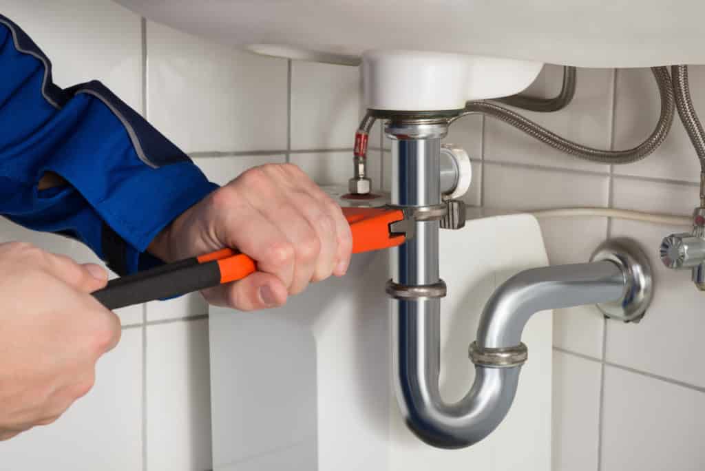Male Plumber Repairing Sink In Bathroom | Plumbing Pros DMV in Gaithersburg, MD